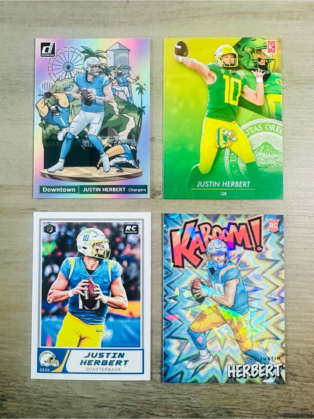 Justin Herbert Rookie Lot of (4) Downtown Kaboom Holo Novelty Cards.